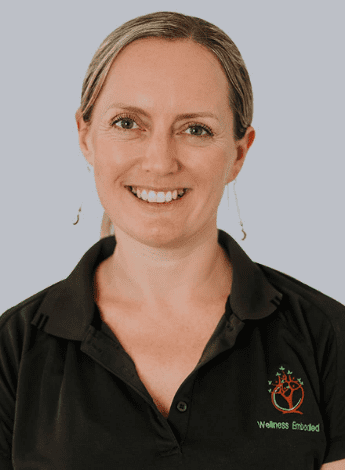 A woman with her hair pulled back wearing a black shirt